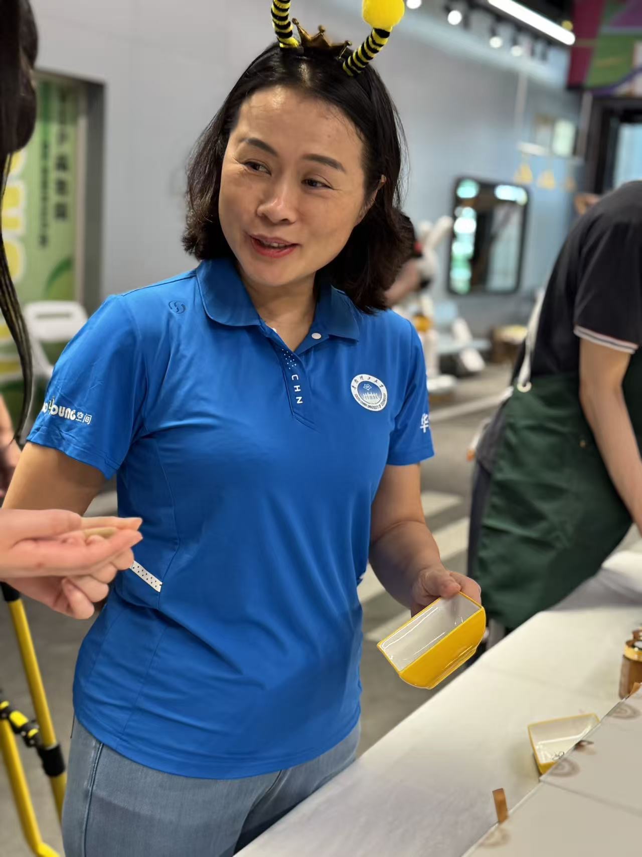 Volunteer offering a honey tasting to a visitor